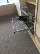 Slide-out wire shoe racks with shoes on Slide-out wire shoe racks with shoes on