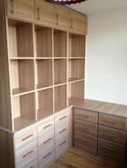 L shape unit of drawers with an open bookcase above