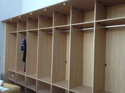 A run of full hanging with shelves above and below along with been lined
