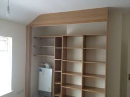 Shallow shelving on the chimney breast and shelving fitted around a boiler