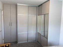L shape wardrobes with wood, coloured glass and mirror