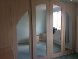 An arch spanning 4 doors with mirror inserts (exclusive to TaylorMade Wardrobes)